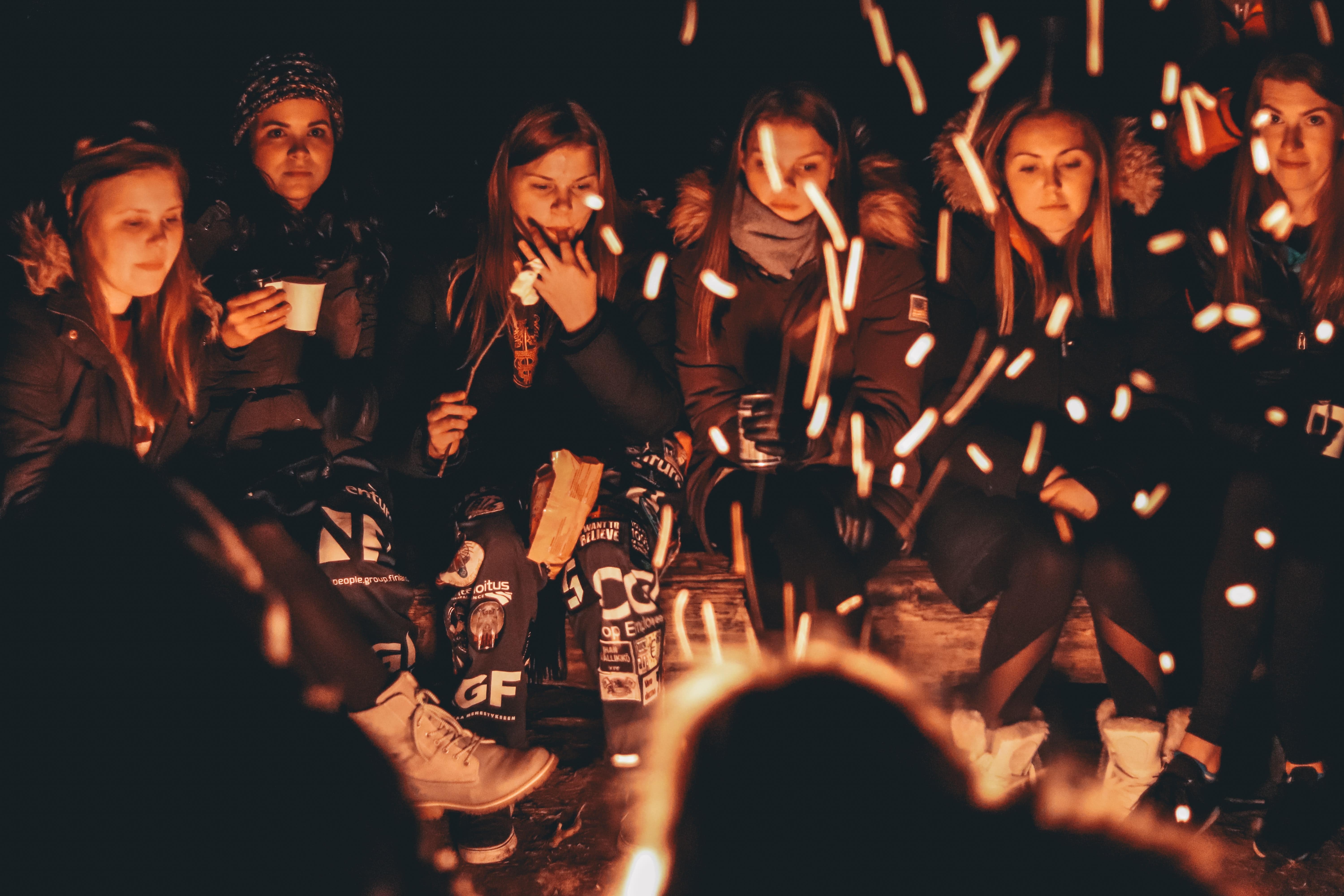 Young Women Around Fire Pit