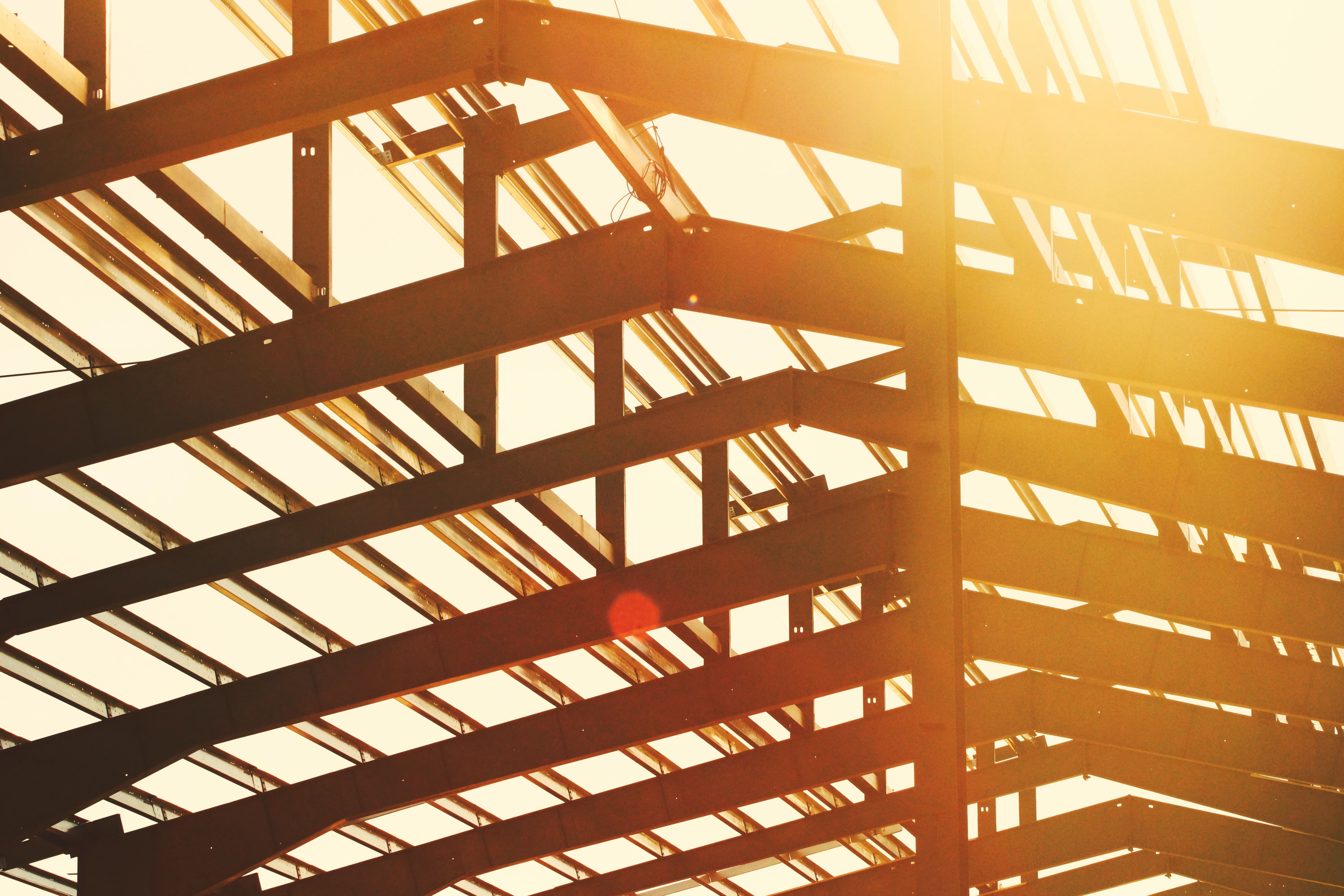 Constructions Workers standing on Ibeams of Large Building