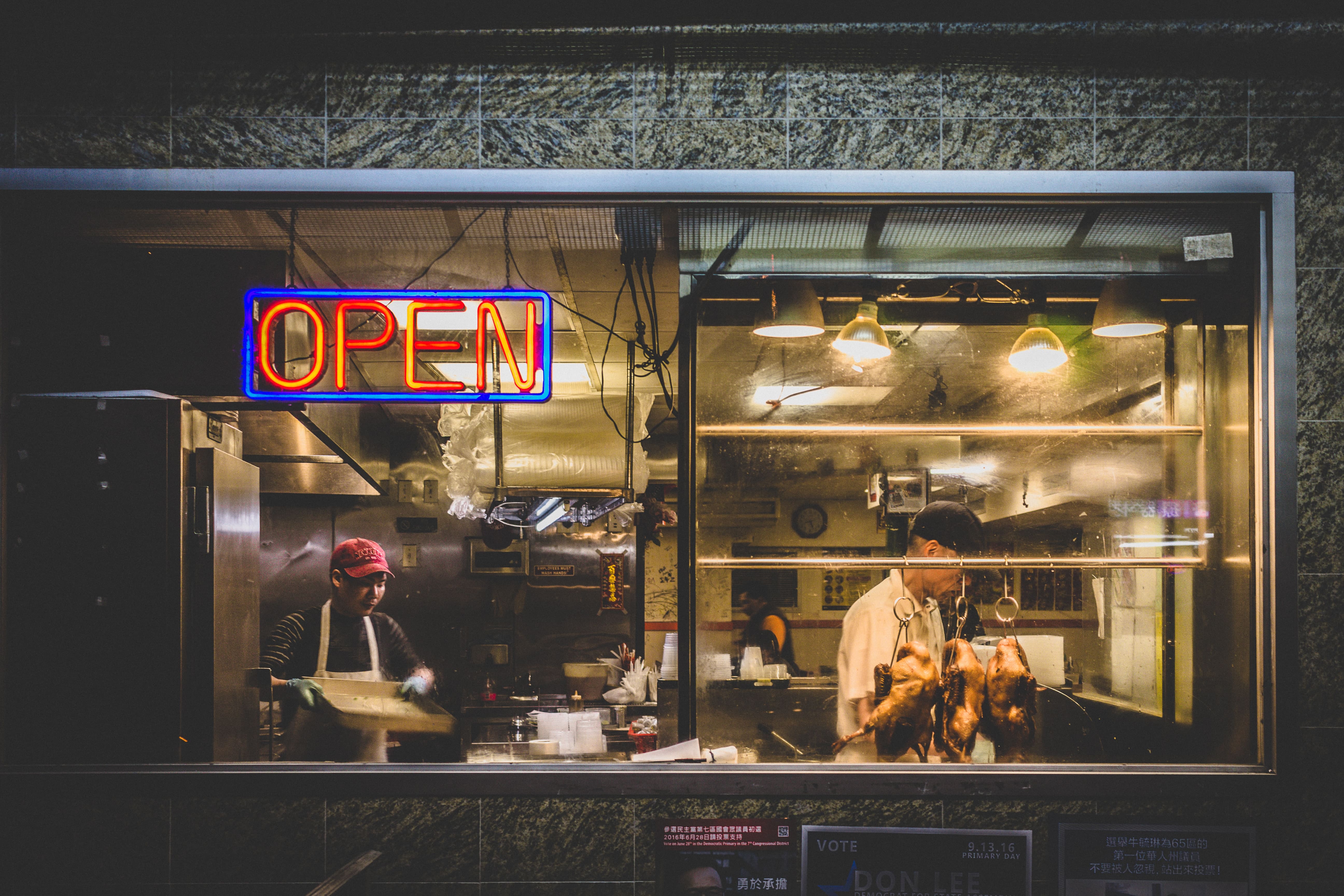 View through the window of an asian restaurant preparing duck