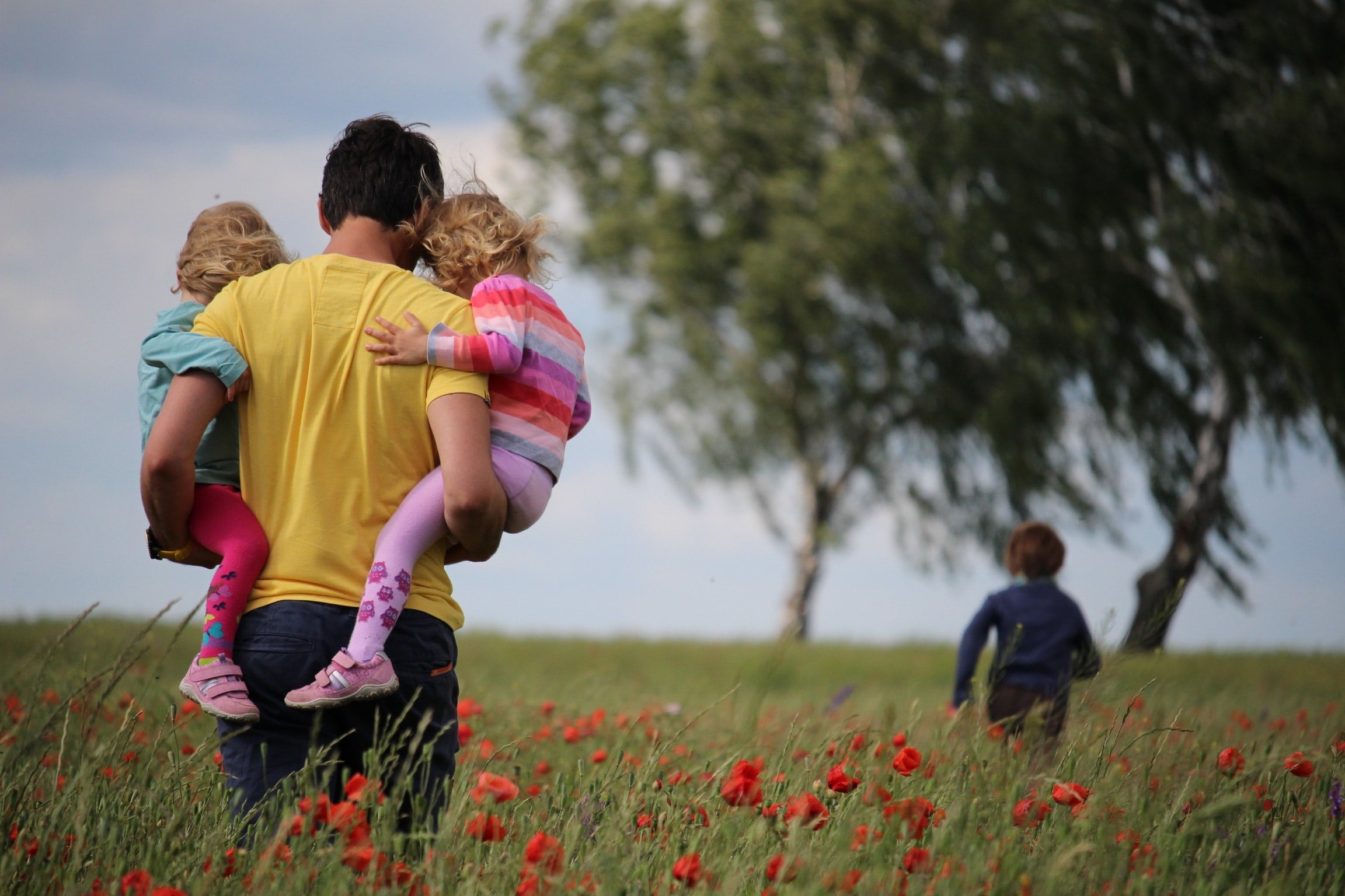 Dad with kids in a poppy field